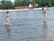 Naughty young nudists play with each other in sand