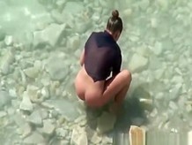 Nudist woman spied in rocky beach