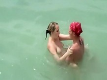 Two nudist couples fucking in the water