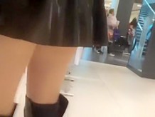 Exhibitionist wife in short latex skirt bending over