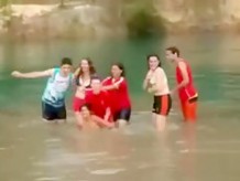 Friends swim in the lake in their underwear